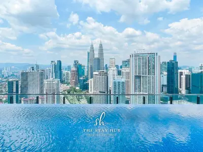a swimming pool with a view of a city skyline at The Luxe & Colony KLCC Skyline Infinity Pool - 5min to Petronas Tower & KL City Center by The Stay Hub in Kuala Lumpur