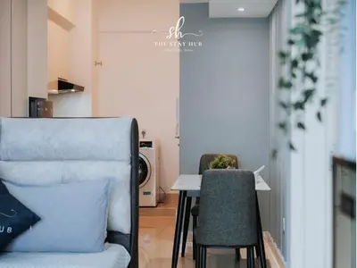 a dining room with a table and two chairs at The Luxe & Colony KLCC Skyline Infinity Pool - 5min to Petronas Tower & KL City Center by The Stay Hub in Kuala Lumpur