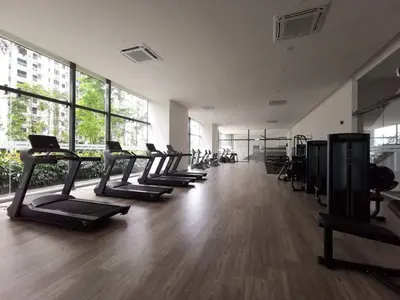 a gym with a row of treadmills in a room at Bangsar South Apartment by Sarah's Lodge @ SouthLink Lifestyle Apartment in Kuala Lumpur