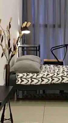 a bed in a room with a table and a lamp at Flexi check in 10min to KLCC next to Hospital Gleneagle in Kuala Lumpur