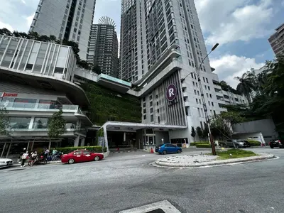 a street with cars parked in front of a building at Eclipse Suites Robertson Bukit Bintang in Kuala Lumpur