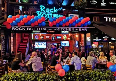 a group of people sitting at a bar with balloons at 2BR Tourists-Friendly Oasis - Heart of the City KL by Verano in Kuala Lumpur