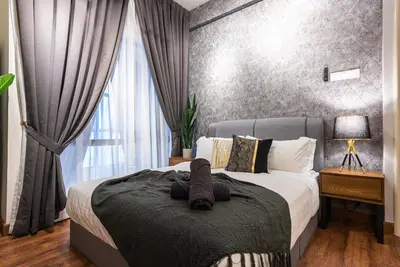 a bedroom with a bed with a teddy bear on it at Urban Duplex v Balcony- 2R2B Up to 7Pax, MontKiara by Verano in Kuala Lumpur