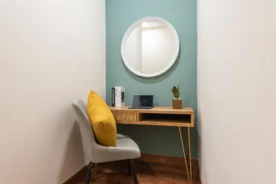 a room with a desk with a mirror and a chair at Urban Duplex v Balcony- 2R2B Up to 7Pax, MontKiara by Verano in Kuala Lumpur