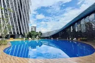 a large blue swimming pool next to a tall building at Urban Duplex v Balcony- 2R2B Up to 7Pax, MontKiara by Verano in Kuala Lumpur