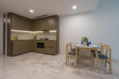 a kitchen and dining room with a table and chairs at Eaton Residence KLCC in Kuala Lumpur