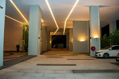 a hallway of a building with a car parked at Eaton Residence KLCC in Kuala Lumpur