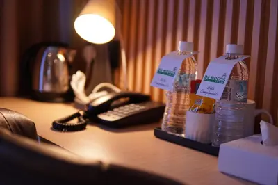 a desk with two bottles of water and a phone at Dê MOCCIS Boutique Hotel in Kuala Lumpur