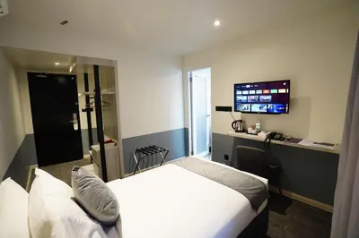 a hotel room with a bed and a flat screen tv at Dê MOCCIS Boutique Hotel in Kuala Lumpur