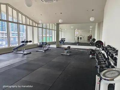 a gym with a lot of treadmills and machines at UNA Serviced Apartment by manatidur in Kuala Lumpur