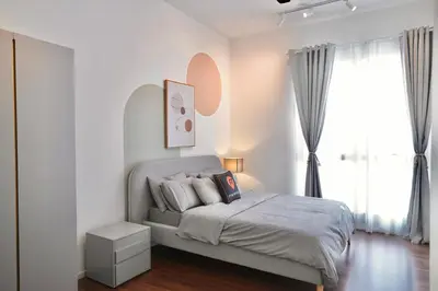 a white bedroom with a bed and a large window at UNA Serviced Apartment by manatidur in Kuala Lumpur