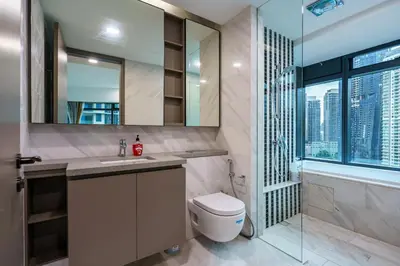 a bathroom with a toilet and a sink and a shower at Eaton Residence KLCC by Yemala in Kuala Lumpur