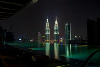 a view of the petronas towers at night at Eaton Residence KLCC by Yemala in Kuala Lumpur