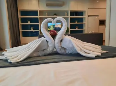 two swans made out of sheets on a bed at The Platinum KLCC By Crystal in Kuala Lumpur