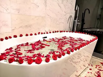 a bath tub filled with red roses in a bathroom at The Platinum KLCC By Crystal in Kuala Lumpur