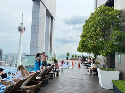 people sitting on the rooftop of a building at The Platinum KLCC By Crystal in Kuala Lumpur