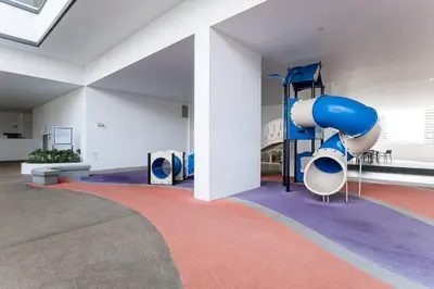 a room with a playground with a blue slide at TR Residence Lovely 3 BR unit 6pax next to Titiwangsa LRT in Kuala Lumpur