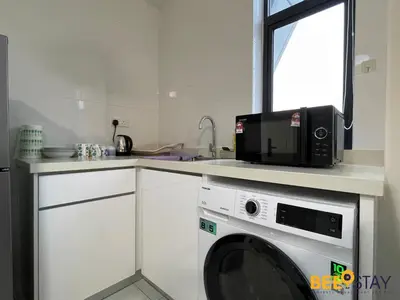 a kitchen with a microwave and a washing machine at Arte Mont Kiara Studio by BeeStay in Kuala Lumpur