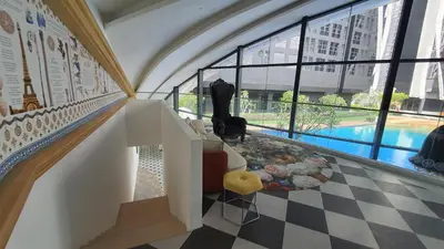 a room with a staircase with a view of a pool at Arte Mont Kiara Studio by BeeStay in Kuala Lumpur