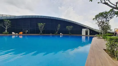 a large swimming pool in front of a building at Arte Mont Kiara Studio by BeeStay in Kuala Lumpur