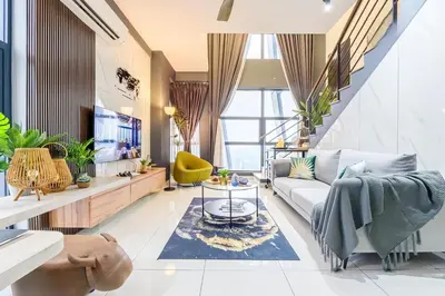 a living room with a couch and a table at Arte Mont Kiara Kuala Lumpur in Kuala Lumpur