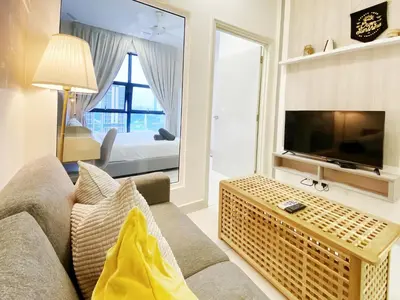 a living room with a couch and a television at Arte Mont Kiara Kuala Lumpur in Kuala Lumpur