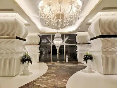a room with a chandelier and white columns at Arte Mont Kiara Kuala Lumpur in Kuala Lumpur