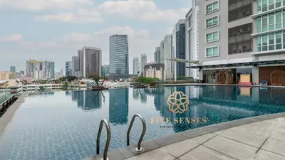 a swimming pool in a city with tall buildings at Dua Sentral Kuala Lumpur, Roam in Kuala Lumpur