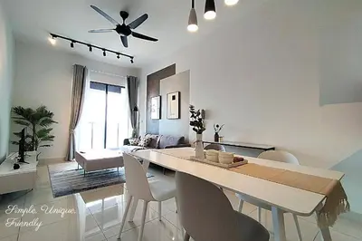 a dining room and living room with a table and chairs at Awesome Designer Suite 3-Beds Near TRX KLCC, Next to IKEA in Kuala Lumpur
