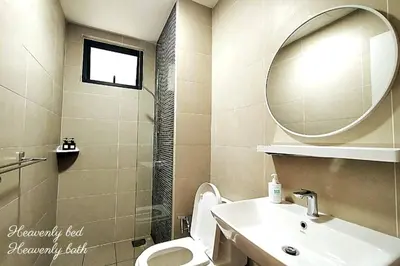 a bathroom with a sink and a toilet and a mirror at Awesome Designer Suite 3-Beds Near TRX KLCC, Next to IKEA in Kuala Lumpur