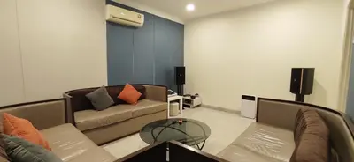a living room with a couch and a table at Bukit Tunku KLCC Grande Villa 11 by Vale Pine in Kuala Lumpur