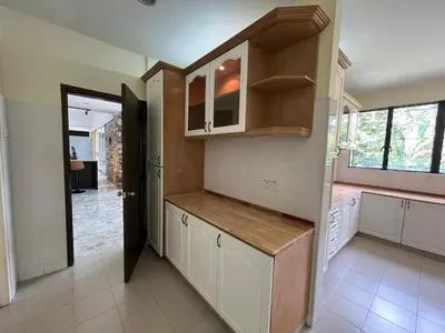 a kitchen with white cabinets and a door to a hallway at Bukit Tunku KLCC Grande Villa 11 by Vale Pine in Kuala Lumpur