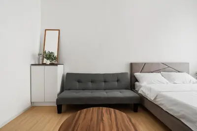 a bedroom with a bed and a chair at Una serviced Apartment in Kuala Lumpur