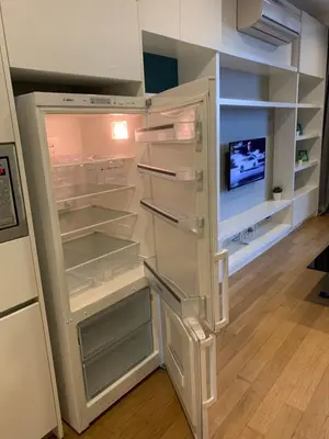 a white refrigerator with its door open and a tv at Platinum Suites by Homie SkyBay in Kuala Lumpur