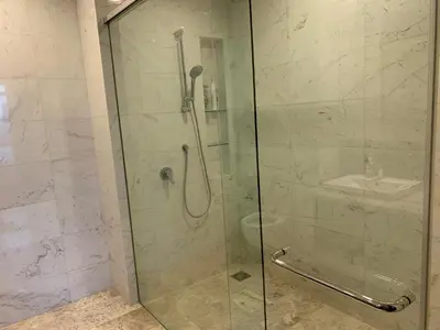 a bathroom with a glass shower with a sink at Platinum Suites by Homie SkyBay in Kuala Lumpur