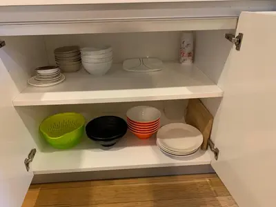 a cupboard filled with plates and bowls on top at Platinum Suites by Homie SkyBay in Kuala Lumpur