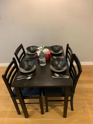 a black table with plates and utensils on it at Platinum Suites by Homie SkyBay in Kuala Lumpur
