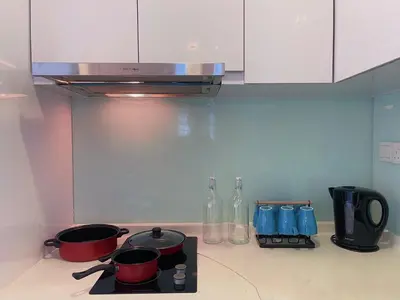 a kitchen with two pots and pans on a stove at LUX SUITES KL City Pavilion Bukit Bintang with INFINITY POOL in Kuala Lumpur
