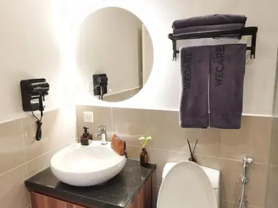a bathroom with a sink and a mirror and a toilet at The President - Bangsar South Mid Valley in Kuala Lumpur