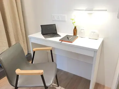 a white desk with a laptop and a chair at The President - Bangsar South Mid Valley in Kuala Lumpur