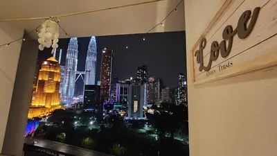 a view of a city at night from a window at Aldridge Residence Coastal KLCC in Kuala Lumpur