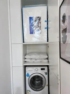 a washer and dryer in a small room at New Arcoris Mont Kiara Huge Balcony for 8 pax 2 BR -Garden- in Kuala Lumpur