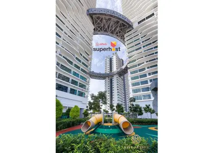a water slide in front of a skyscraper at Datum Jelatek Sky Residence KLCC, Five Senses in Kuala Lumpur