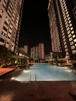 a large swimming pool in a city at night at Dsistyle Islamic House in Kuala Lumpur