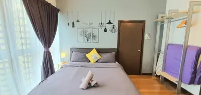 a bedroom with a bed with purple and yellow pillows at Regalia Suites KLCC View Rooftop Infinity Pool by SHI in Kuala Lumpur