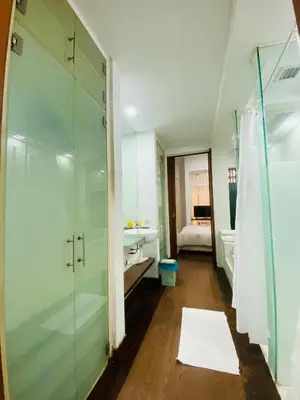 a bathroom with a shower and a sink at Peninsula Residences All Suite Hotel in Kuala Lumpur