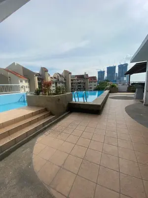 a swimming pool on the roof of a building at Peninsula Residences All Suite Hotel in Kuala Lumpur