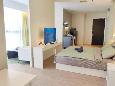 a bedroom with a bed and a desk with a television at Panoramic City - Bangsar South Mid Valley in Kuala Lumpur