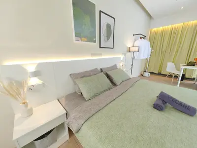 a living room with a bed and a table at Panoramic City - Bangsar South Mid Valley in Kuala Lumpur