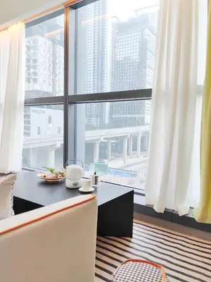 a dining room with a table and a large window at Panoramic City - Bangsar South Mid Valley in Kuala Lumpur